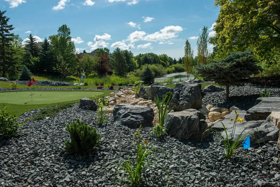Rock garden with boulders, decorative rock and plantings